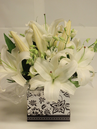 This stunning mix of white oriental lillies lisianthus and orchids are 