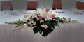 Oriental, pink roses and orchid long and low.