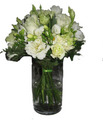 white sympathy of seasonal flowers in a vase