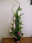 Oriental lilies and roses in a ceramic pot