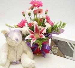 Mothers day flower arrangement    
scented teddy and chocolates
